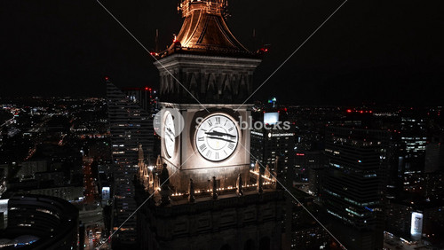 Aerial Night View Of The Palace Of Culture And Science Near Downtown Business Skyscrapers In The City Center.