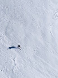 Aerial View Of Solo Skier On Snowy Slope