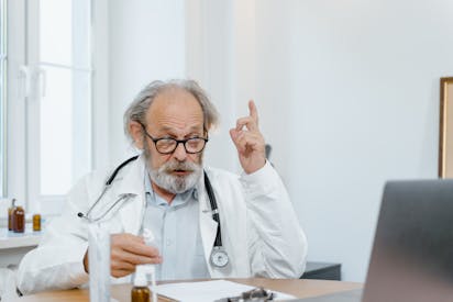 An Elderly Doctor Giving Online Consultation