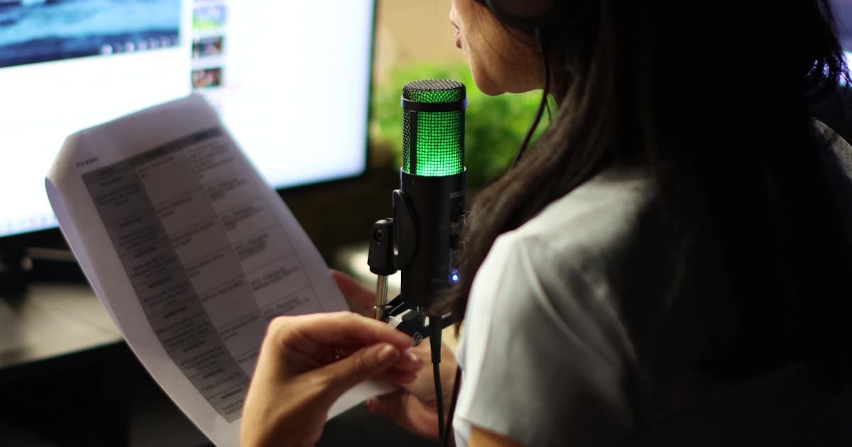 A Woman Is Listening To Music While Reading A Paper