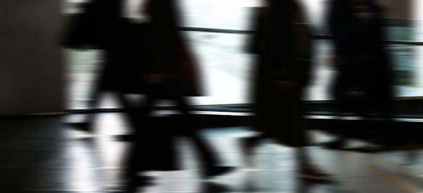 Blurred Silhouettes Of Commuters Indoors