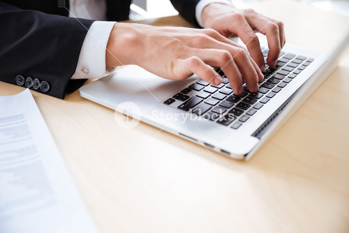 Closeup Of Hands Of Professional Using Laptop At The Table