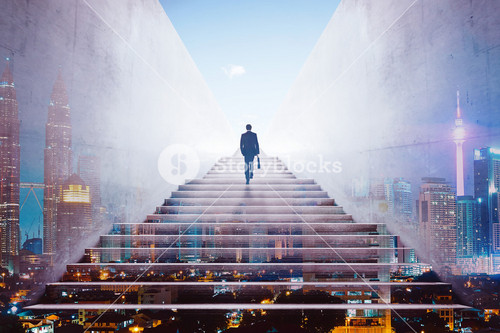 Rear View Of A Businessman Climbing Stairs To Get To A Large City Center. Concept Of Success And Appreciation. Double Exposure