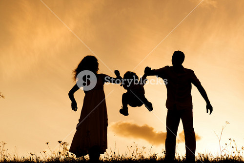 Silhouettes Of Happy Parents Having Fun With Their Children